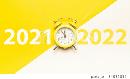 New year clock 2022. Retro style yellow clock in happy Christmas midnight. Countdown to happy xmas on yellow background. Merry Christmas and Happy New Year. New year clock 2022. Retro style yellow clock in happy Christmas midnight. Countdown to happy xmas on yellow background. Merry Christmas and Happy New Year. 84035052