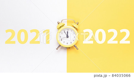 Christmas flat lay 2022. Retro style yellow clock in happy xmas midnight. Countdown to new year on happy xmas yellow background. Merry Christmas and Happy New Year. 84035066