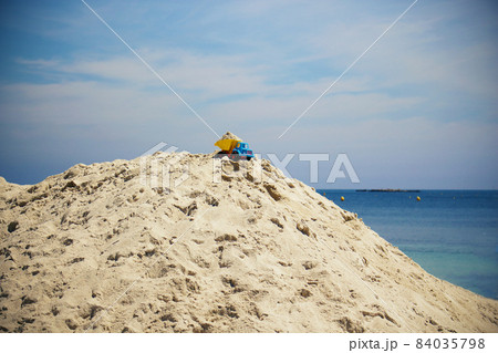 Toy truck stuck on beach sand hill top Toy truck stuck on beach sand hill top 84035798