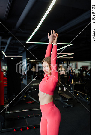 Beautiful muscular fit woman exercising, building muscles in gym 84039401