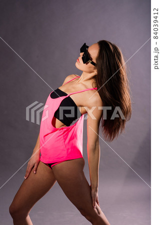 Happy beautiful girl dancing and celebrating standing in full length, isolated on studio background Happy beautiful girl dancing and celebrating standing in full length, isolated on studio background 84039412