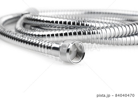 Shower hose on a white background. Silver shower hose close-up. Shower hose on a white background. Silver shower hose close-up. 84040470