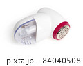 Lint remover on a white background. Electric lint remover close-up on a white background. 84040508