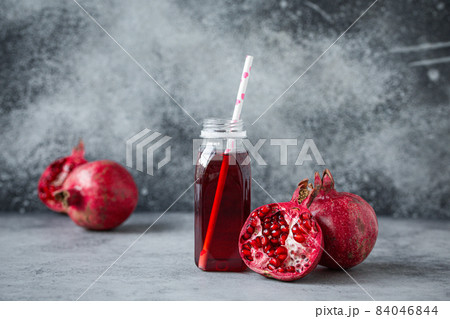 Pomegranate juice in bottle and fruit 84046844