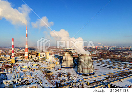 View of pipes of heating station from above on clear winter day. Smoke comes from chimneys. Heating View of pipes of heating station from above on clear winter day. Smoke comes from chimneys. Heating 84047458
