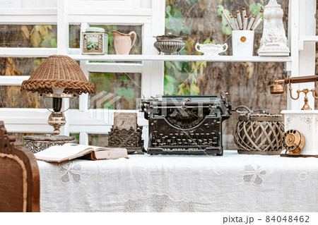 Desk with Vintage typewriter, retro lamp, old phone Desk with Vintage typewriter, retro lamp, old phone 84048462