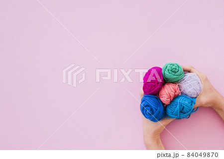 elevated view hand holding colorful wool pink background 2. High quality beautiful photo concept 84049870