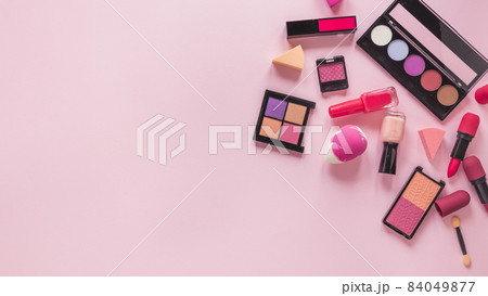 different cosmetics types scattered pink table. High quality beautiful photo concept different cosmetics types scattered pink table. High quality beautiful photo concept 84049877