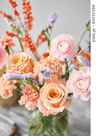 Finished flower arrangement in a vase for home. Flowers bunch, set for interior. Fresh cut flowers for decoration home. European floral shop. Delivery fresh cut flower. 84050388