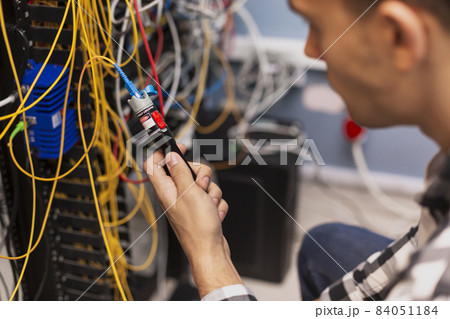 engineer man testing optical fiber. High quality beautiful photo concept engineer man testing optical fiber. High quality beautiful photo concept 84051184