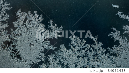 Frosty winter background, ice crystals on glass Frosty winter background, ice crystals on glass 84051433