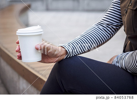 Woman Hand holding Paper Cup coffee Park Outdoor People lifestyle 84053768