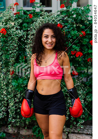Woman power, self defence concept. Portrait of attractive serious fit boxer, ready for fight Woman power, self defence concept. Portrait of attractive serious fit boxer, ready for fight 84054647