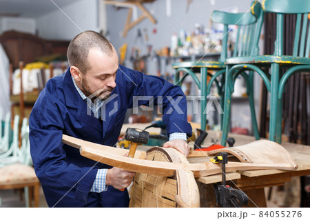 Craftsman repairing antique furniture 84055276