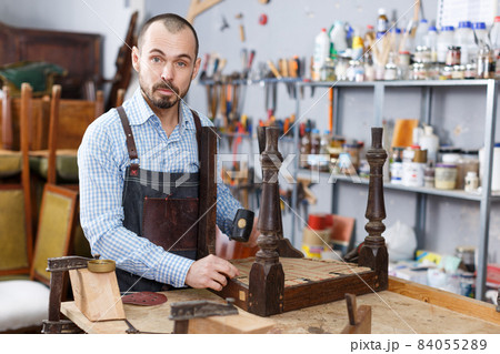 Craftsman using carpentry tools for restoration 84055289