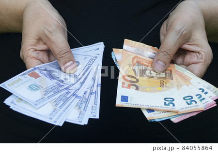 Euro and dollar banknotes in hands. Economy concept, currency exchange Euro and dollar banknotes in hands. Economy concept, currency exchange 84055864