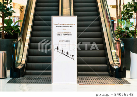 Always Practice and Social Distancing Text with thai and chinese language with the same meaning over the billboard 84056548