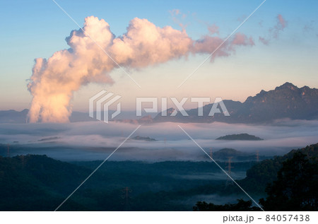 Sea of fog and coal-fired power plant. 84057438