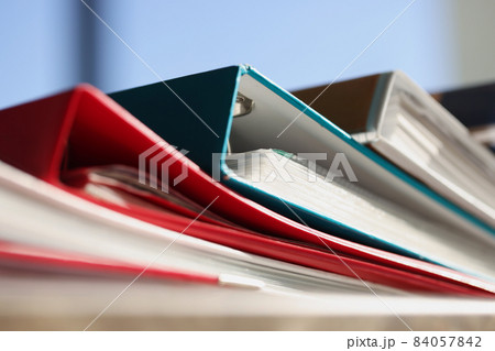Stack of colourful folders for documents on table Stack of colourful folders for documents on table 84057842