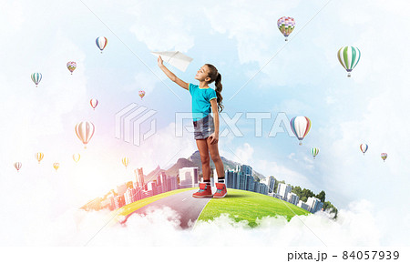 Concept of careless happy childhood with girl dreaming about future Concept of careless happy childhood with girl dreaming about future 84057939