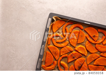 Baked sweet pumpkin on a baking sheet 84059358