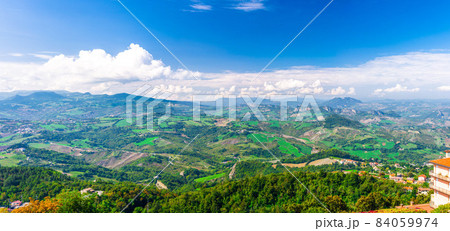 Aerial top panoramic view of landscape with valley, green hills, fields and villages of Republic San Marino Aerial top panoramic view of landscape with valley, green hills, fields and villages of Republic San Marino 84059974