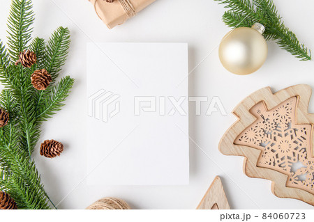 Christmas 5x7 card mockup template with fir twigs and golden stars on white background 84060723