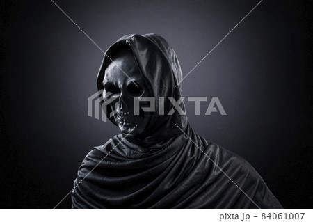Grim reaper over dark misty background Grim reaper over dark misty background 84061007