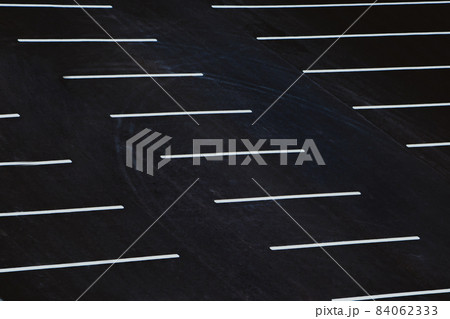 Empty parking during quarantine in the city. White markings for cars on black asphalt. 84062333