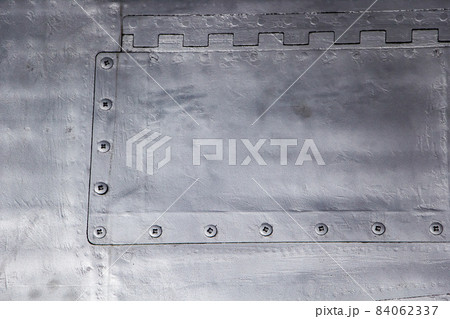 Aircraft skin close up. Rivets on gray metal. Aluminum texture 84062337