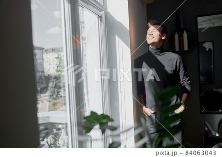 Male happy smiling hairdresser at his modern salon Male happy smiling hairdresser at his modern salon 84063043