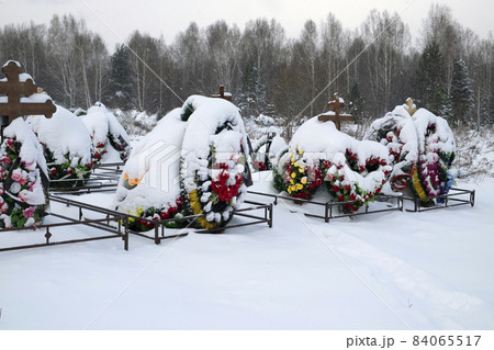Winter cemetery. Graves with floral wreaths. A lot of snow Winter cemetery. Graves with floral wreaths. A lot of snow 84065517