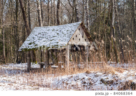 Forest gazebo. A place in the woods for travelers to relax. A table and benches in the forest. Forest gazebo. A place in the woods for travelers to relax. A table and benches in the forest. 84068364