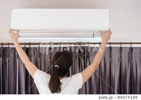 Woman fixing - repairing air conditioner filter. Woman fixing - repairing air conditioner filter. 84074199