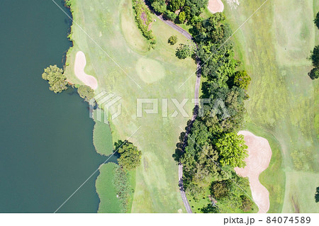 Aerial view of the green golf course in Thailand Beautiful green grass and trees on a golf field with fairway and putting green in summer season 84074589