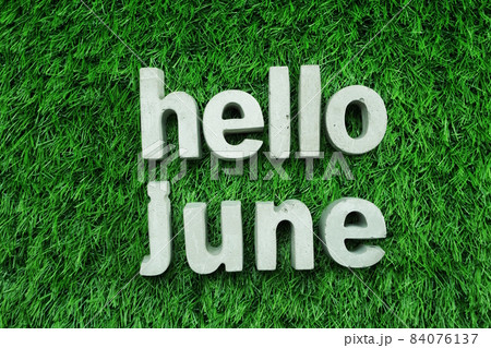 Hello June made from concrete alphabet top view on green grass Hello June made from concrete alphabet top view on green grass 84076137