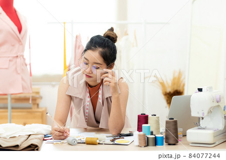 Owner business asian young women fashion designer working on her designer in the showroom, Owner business asian young women fashion designer working on her designer in the showroom, 84077244