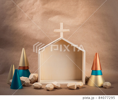 Minimal wooden Church and paper treess on brown paper background. DIY organic sustainable Christmas decoration. Minimal wooden Church and paper treess on brown paper background. DIY organic sustainable Christmas decoration. 84077295