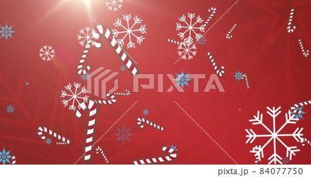 Image of falling snowflakes and candy corn on red background 84077750