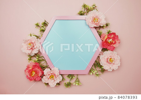Blue Hexagon background and pink border decorate with flowers on pink background 84078393