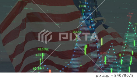 Image of financial data processing over person holding american flag Image of financial data processing over person holding american flag 84079078