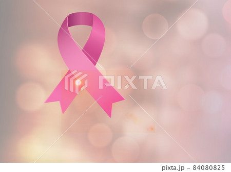 Digitally generated image of pink ribbon icon against spots of light on pink background 84080825
