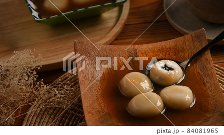 Close up black sesame dumplings in ginger soup. 84081965