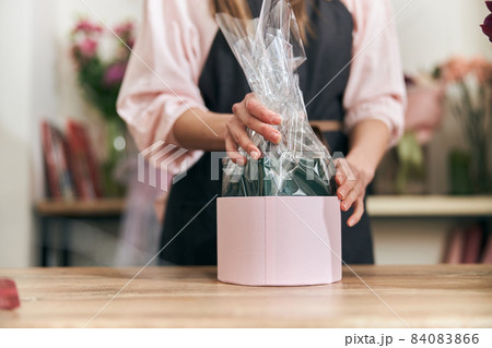 Professional florist young woman is doing bouquets at flower shop Professional florist young woman is doing bouquets at flower shop 84083866