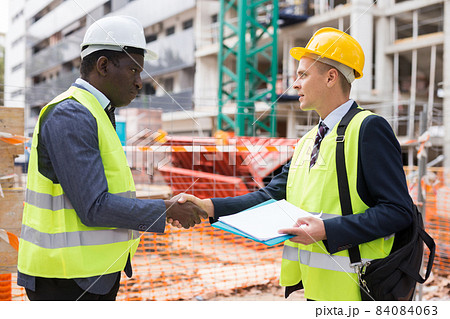 Two successful civil engineers exchange a friendly handshake 84084063