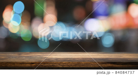 Empty wooden table top with beautiful light bokeh in background for product showing. 84084737