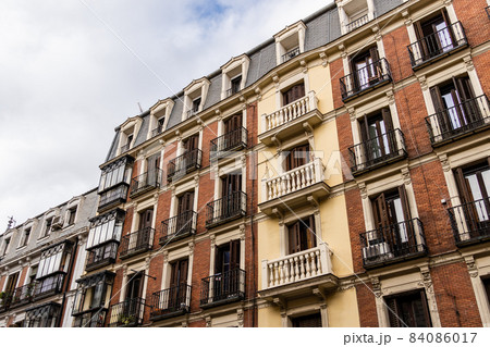 Old residential building facade against sky in Madrid Old residential building facade against sky in Madrid 84086017