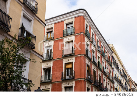 Old residential building facade against sky in Madrid Old residential building facade against sky in Madrid 84086018