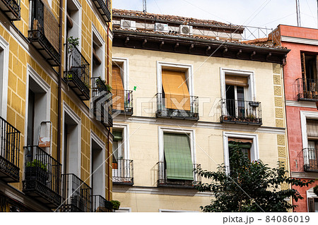 Old residential building facade against sky in Madrid Old residential building facade against sky in Madrid 84086019