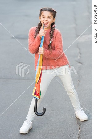 Girl child long hair ready meet fall weather with folded umbrella. Girl child long hair ready meet fall weather with folded umbrella. 84086059